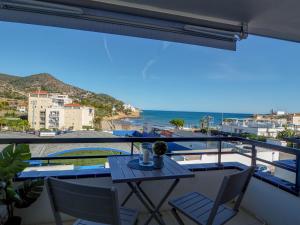 a balcony with a table and chairs and the ocean at The Beach Studio by Hello Homes Sitges in Sitges