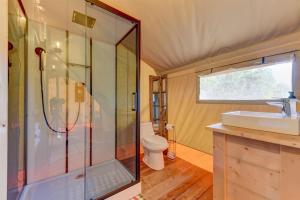 a bathroom with a shower and a sink and a toilet at 12 Fires Luxury Glamping with AC #5 in Johnson City