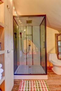 a bathroom with a shower and a toilet at 12 Fires Luxury Glamping with AC #5 in Johnson City