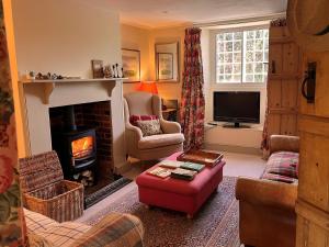 a living room with a fireplace and a tv at 3 Bed in Shaftesbury 92395 in Melbury Abbas