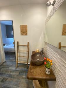 a bathroom with a sink on a wooden table at S'accabbadora Guest House in Alghero
