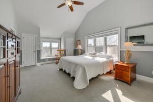 a bedroom with a bed and a ceiling fan at Large Home with Indoor Basketball Court and Game Room! in Wisconsin Dells