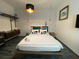 a bedroom with a large white bed in a room at S'accabbadora Guest House in Alghero