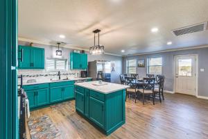 a kitchen with green cabinets and a dining room at Charming Vacation Home 4 Mi to Whitney Lake! in Whitney