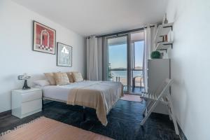 a bedroom with a bed and a view of the ocean at El Balcón de Samil in Vigo