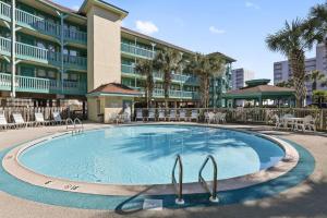 a large swimming pool in front of a hotel at Sea Breeze 305 in Gulf Shores