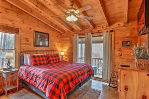 a bedroom with a bed and a ceiling fan at Pet-Friendly Mountain Retreat Fire Pit Hot Tub in Blue Ridge