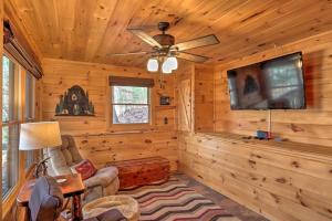 a living room with a ceiling fan and a tv at Pet-Friendly Mountain Retreat Fire Pit Hot Tub in Blue Ridge