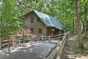 a log cabin in the woods with a bridge at Pet-Friendly Mountain Retreat Fire Pit Hot Tub in Blue Ridge