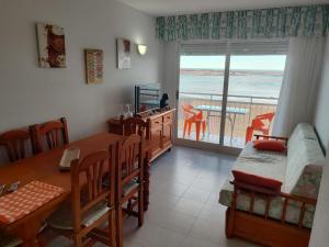 a room with a dining table and a room with a balcony at Apartamentos Forner in Peniscola