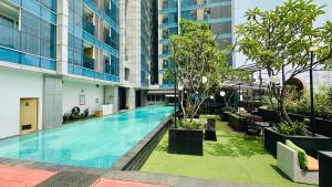 a swimming pool in the middle of a building at Tamansari Hive Cawang by Villaloka in Jakarta