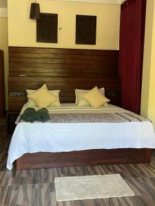 a bedroom with a large bed with a wooden headboard at Green turtle in Tangalle