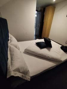ein Bett mit zwei Kissen darüber in der Unterkunft Vibe House Madisson in Braşov
