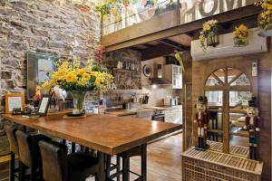 a kitchen with a wooden table with flowers on it at Mia Home, Terre Marine in Riomaggiore