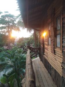 a large tree trunk on a porch of a house at Orchid Home in Koh Tao