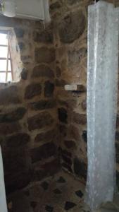 a room with a stone wall and a window at Finca La Sara in Ubaté