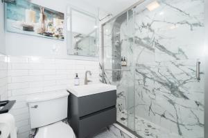 a bathroom with a shower with a sink and a toilet at 21Floor-Renovated 2BR,1Bath King and Queen Bed and Parking in Atlanta +29 photos