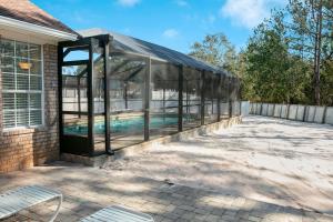 a glass house with a swimming pool inside at Happy Ours in Foley