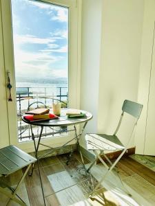 a table and a chair in a room with a window at Ventana a la Ría in Ferrol