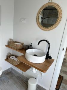 a bathroom with a sink and a mirror at Ventana a la Ría in Ferrol