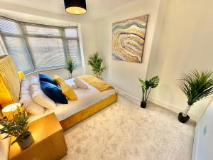 a bedroom with a bed with pillows and a window at Large Four Bedroom - With Hot Tub and Parking - Sleeps 8 in Poole