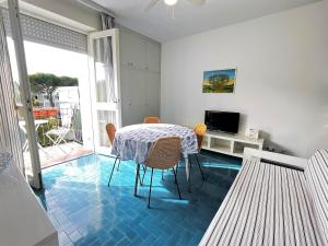 a dining room with a table with a blue floor at Villa Ninfea in Grado