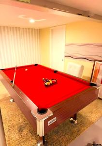 a red pool table in a room at Fully Equipped Cozy 4/5 BR in Chicago