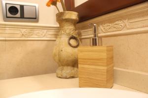 a sink with a faucet next to a vase at Gran Apartamento Andévalo in El Cerro de Andévalo +34 photos