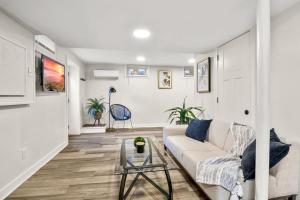 a living room with a couch and a glass table at BRAND NEW Private and Modern 2BR Unit in Minneapolis