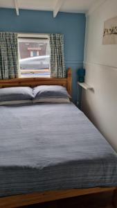 a bedroom with a large bed with a window at Turtle Lodges 29 - Riverside in Builth Wells