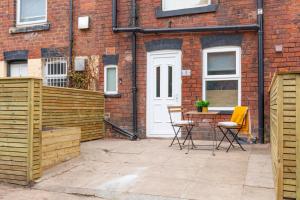 a patio with a table and chairs in front of a building at Cosy One Bed Apt in Leeds City in Leeds