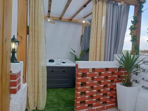 una habitación al aire libre con una pared de ladrillo y una mesa en Casinhas do Miga en Santa Comba Dão