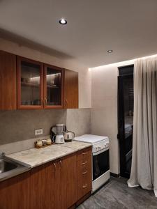 a kitchen with wooden cabinets and a white stove top oven at Casa L in Ulcinj +168 photos