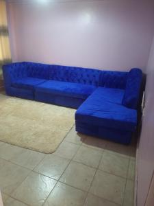 a blue couch sitting in a living room at Verona Apartments in Thika