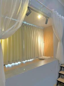 a room with a window with white curtains at Stay&Chill S.6 - Tranquil home in Saigon's heart in Ho Chi Minh City
