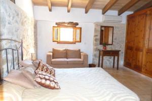 a bedroom with a bed and a couch at Casa Villa Las Encinas in Pollença +40 photos