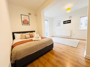 a bedroom with a bed and a hard wood floor at Crouch End Garden Apartment! in London