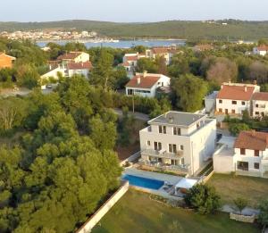 an aerial view of a large white house with a pool at House Barbara in Banjole