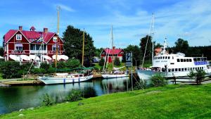 a group of boats docked in a marina with houses at The Cozy Little House in Motala