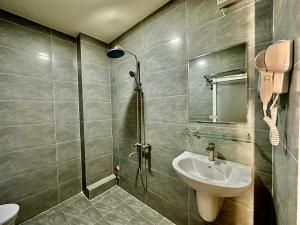 a bathroom with a sink and a shower at Dorms Bui Vien - Walking street in Ho Chi Minh City