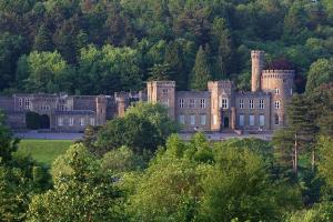 an old castle with trees in front of it at SleepyStays 3 Bedroom Modern & Central Location Sleeps 4 in Merthyr Tydfil