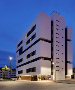 a rendering of a white building at night at Nuvō Hotel Boutique in Oviedo