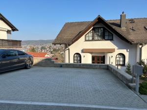 a car parked in front of a house at Ferienwohnung Panoramablick in Erbach im Odenwald