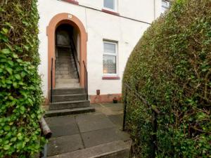 an entrance to a white building with a stairway at Pass the Keys Spacious Murrayfield Flat in Edinburgh