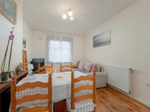 a bedroom with a bed and a table and a couch at Pass the Keys Spacious Murrayfield Flat in Edinburgh