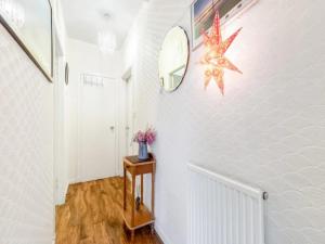 a hallway with a mirror and a star on the wall at Pass the Keys Spacious Murrayfield Flat in Edinburgh