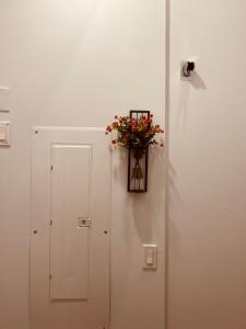 a white door with a vase of flowers on it at Sweet home in Surrey