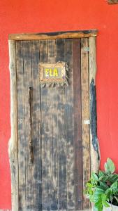 a wooden door with the word elma written on it at A Chave da Montanha 