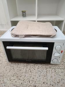 a microwave oven with a towel on top of it at Azalea garden appartment with mountain view in Kremasti