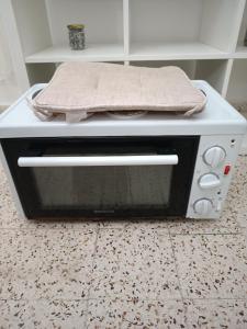 a microwave oven with a towel on top of it at Azalea garden appartment with mountain view in Kremasti